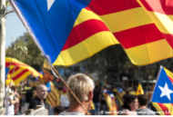 Person holding Catalan blue-starred independence flag at 2012 independence rally